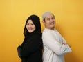 Portrait of happy Asian muslim couple smiling, husband and wife standing leaning on each other back to back, family Royalty Free Stock Photo