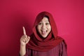 Muslim Woman Having Bright Idea, Looking at Camera Smiling and Pointing Up Royalty Free Stock Photo