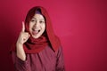 Muslim Woman Having Bright Idea, Looking at Camera Smiling and Pointing Up Royalty Free Stock Photo