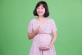 Portrait of happy Asian pregnant woman giving thumbs up Royalty Free Stock Photo