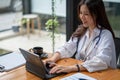 Portrait happy asian woman doctor, Telemedicine concept. Asian female doctor talking with patient using laptop online Royalty Free Stock Photo