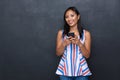 Portrait of a happy asian woman in dress standing isolated over gray background Royalty Free Stock Photo