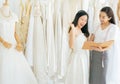 Portrait of happy asian woman holding credit card in wedding dress store owner,Beautiful female successful dressmaker in shop and Royalty Free Stock Photo