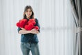 Woman with many heart shaped red pillow in her arms. Valentine day