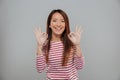 Portrait of a happy asian woman showing ok gesture