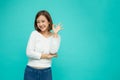 Portrait of happy asian young woman gesture or showing hand ok and looking at camera isolated on green background. Royalty Free Stock Photo