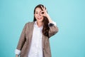 Portrait of happy asian young woman gesture or showing hand ok and looking at camera isolated on green background, Female feeling Royalty Free Stock Photo