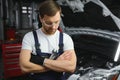 Portrait Of A Happy Auto Mechanic Cleaning Hands With Cloth Royalty Free Stock Photo
