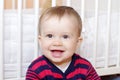 Portrait of happy baby age of 1 year against white bed Royalty Free Stock Photo