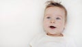 Portrait of happy baby boy lying on soft white pillow Royalty Free Stock Photo