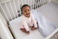 Portrait Of Happy Baby Girl Playing In Nursery Cot Royalty Free Stock Photo