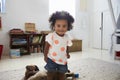 Portrait Of Happy Baby Girl Playing With Toys In Playroom Royalty Free Stock Photo