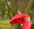 Portrait of happy baby with red umbrella outdoors Royalty Free Stock Photo