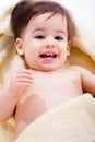 Portrait of a happy baby wrapped in yellow towel Royalty Free Stock Photo