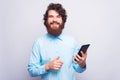 Portrait of happy bearded and handsome man using tablet over white wall Royalty Free Stock Photo