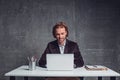 Outgoing businessman typing in notebook computer