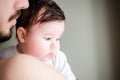 Portrait of happy beautiful baby girl sitting oh fathers hands