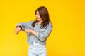 Portrait of happy beautiful brunette young woman in denim casual style standing, toothy smiling, touching and checking her smart