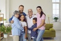 Happy children, parents and grandparents standing in the living room, hugging and smiling Royalty Free Stock Photo