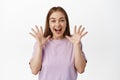 Portrait of happy beautiful girl, rejoicing, scream from joyful and positive feelings, shaking hands and telling big Royalty Free Stock Photo