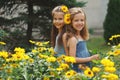 Portrait of happy beautiful girls in flowerbed Royalty Free Stock Photo