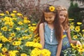 Portrait of happy beautiful girls in flowerbed Royalty Free Stock Photo