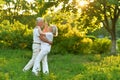 Happy beautiful senior couple dancing in summer park Royalty Free Stock Photo