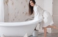 Portrait of happy beautiful woman with brown long hair in bathroom