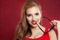 Portrait of happy beautiful woman. Perfect female model face closeup on red background Royalty Free Stock Photo