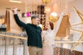 Portrait of happy beautiful young couple in love holding shopping bags standing in mall and looking at each other. Royalty Free Stock Photo