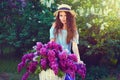 Portrait of a happy beautiful young girl with vintage bicycle and flowers on city background in the sunlight outdoor Royalty Free Stock Photo