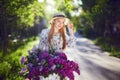 Portrait of a happy beautiful young girl with vintage bicycle and flowers on city background in the sunlight outdoor Royalty Free Stock Photo