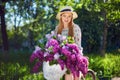 Portrait of a happy beautiful young girl with vintage bicycle and flowers on city background in the sunlight outdoor Royalty Free Stock Photo