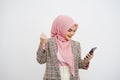 Portrait of a happy beautiful young muslim businesswoman pink hijab celebrating success with arms raised, fists clenched Royalty Free Stock Photo