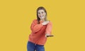 Portrait of happy beautiful young woman smiling and dancing isolated on yellow background Royalty Free Stock Photo