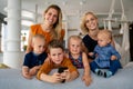 Portrait of happy big family. Gay couple of women smiling and having fun with children at home Royalty Free Stock Photo