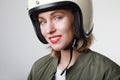 Portrait of happy biker young woman, making funny face, wearing white helmet, with red lips. Studio background. Royalty Free Stock Photo