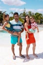 Portrait of happy biracial family embracing by the swimming pool Royalty Free Stock Photo