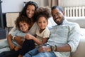 Portrait of happy biracial family with kids on couch