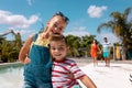 Portrait of happy biracial family taking smiling by the swimming pool Royalty Free Stock Photo