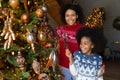 Portrait of happy biracial mom and daughter celebrate Christmas Royalty Free Stock Photo