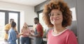 Portrait of happy biracial woman preapring meal with diverse friends in kitchen, slow motion