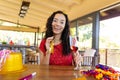 Portrait of happy biracial young woman with champagne flute enjoying party on video call Royalty Free Stock Photo