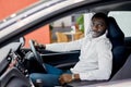 Portrait of happy black businessman inside of luxurious car