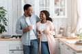Portrait Of Happy Black Couple Drinking Coffee And Relaxing Together In Kitchen Royalty Free Stock Photo