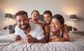 Portrait of happy black family on a bed with children, carefree, relaxing and playing in a bedroom together. Young Royalty Free Stock Photo