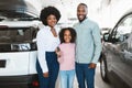 Portrait of happy black family with car key smiling at camera, buying new vehicle in auto dealership Royalty Free Stock Photo