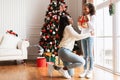 Portrait of happy black family celebrating Christmas exchanging presents Royalty Free Stock Photo