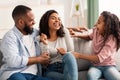 Portrait of a happy black family tickling at home Royalty Free Stock Photo