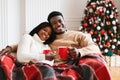 Portrait of happy black family watching tv on Xmas eve Royalty Free Stock Photo